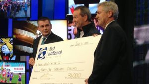 First National Real Estate donates funds for MND research