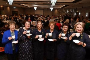 Raising their cups for charity