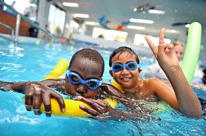 Migrant children get into the swim